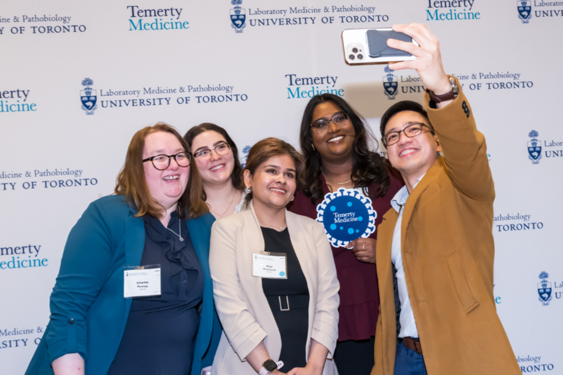 a group of people taking a selfie