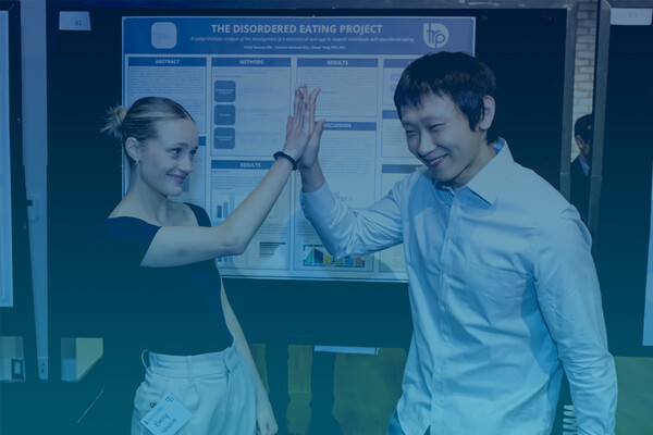 Two TRP students high-fiving at the LMPRC 2023