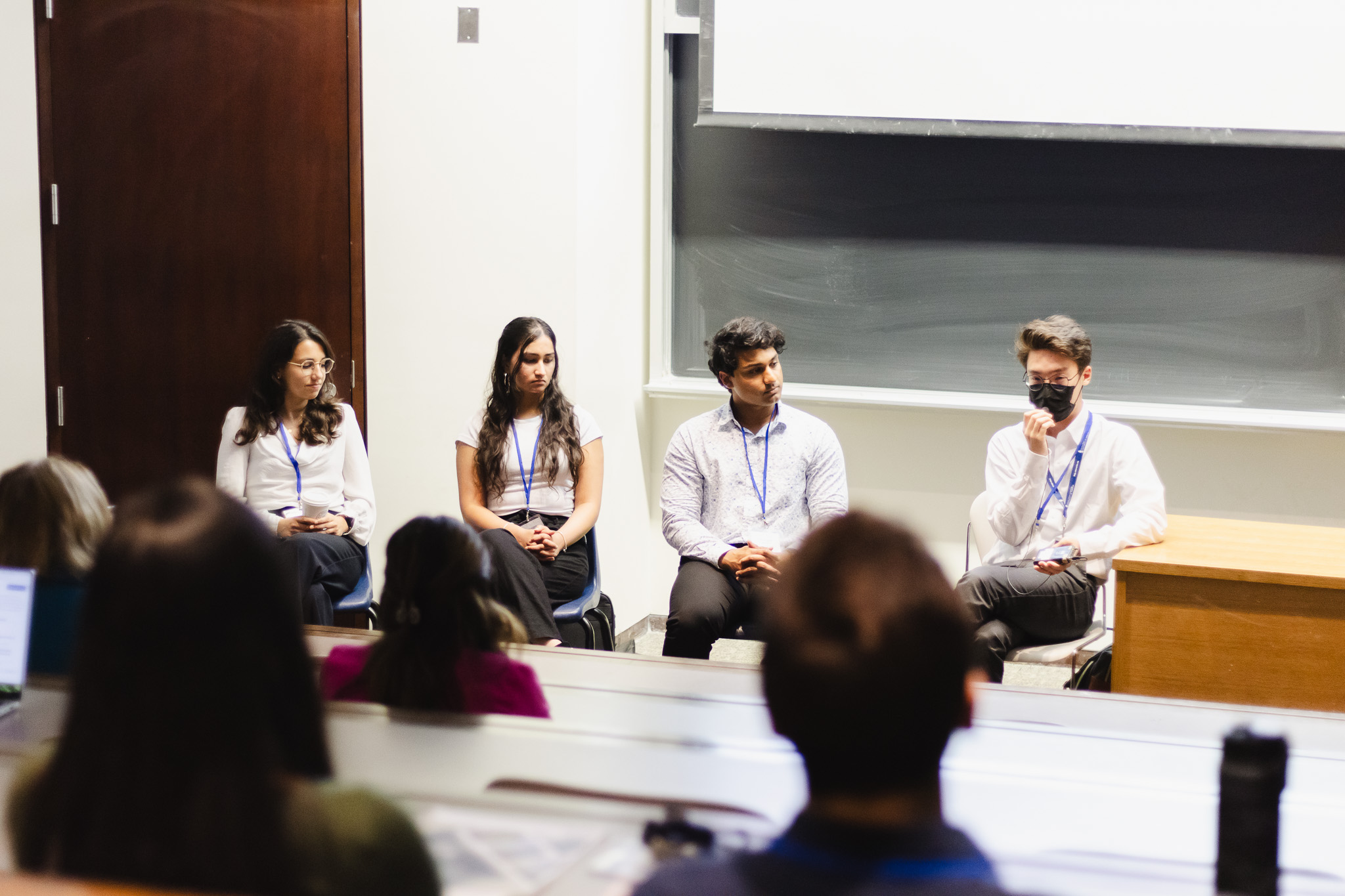 Mikhail Lobo (centre right) speaking at the Temerty Faculty of Medicine Research Showcase 2024