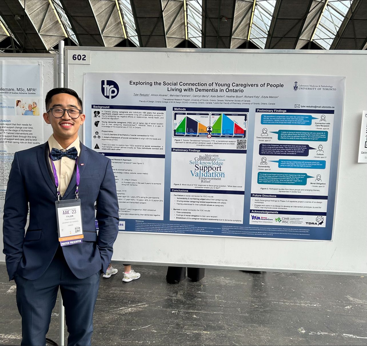 Tyler Redublo standing in front of his poster at the Alzheimer's Association International Conference 2023